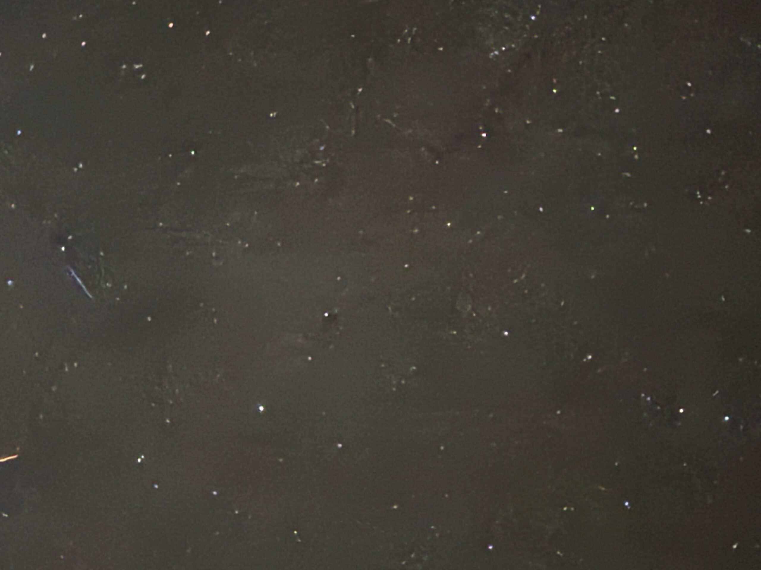 Phone photo of the Milky Way over Lake Lure, a pale band of stars across a dark sky